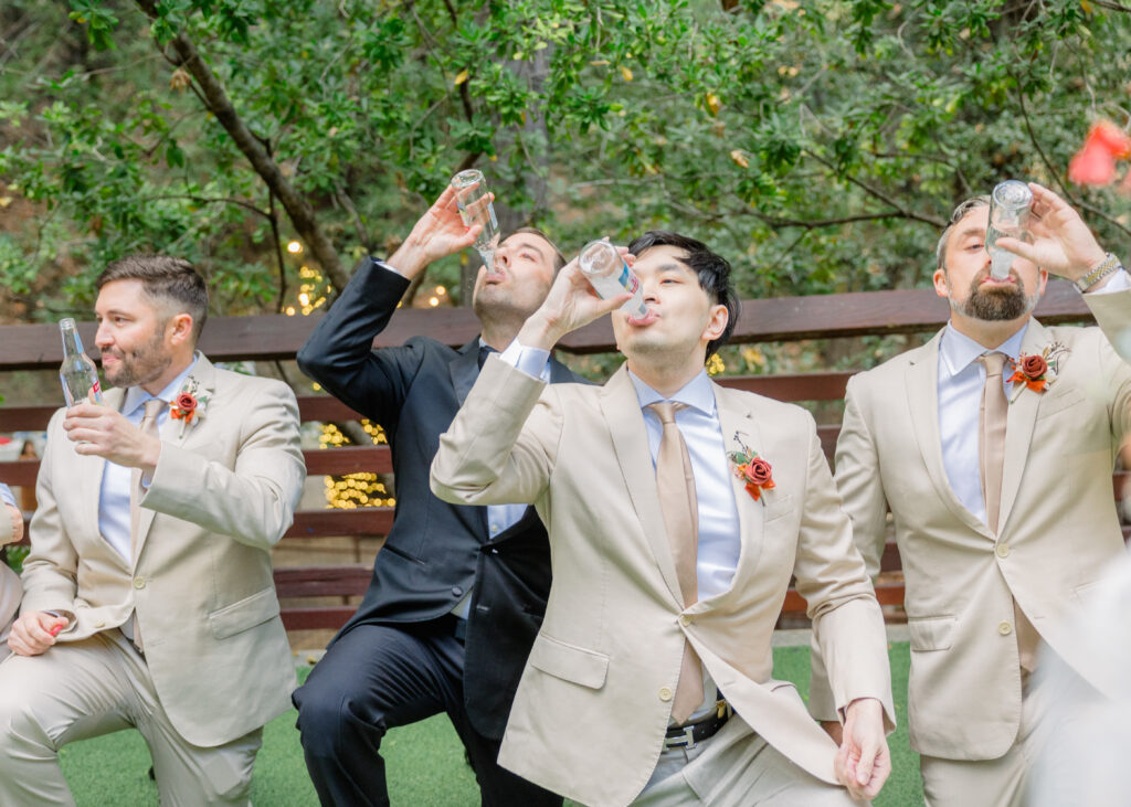 Groomsmen drinking wine coolers at their wedding