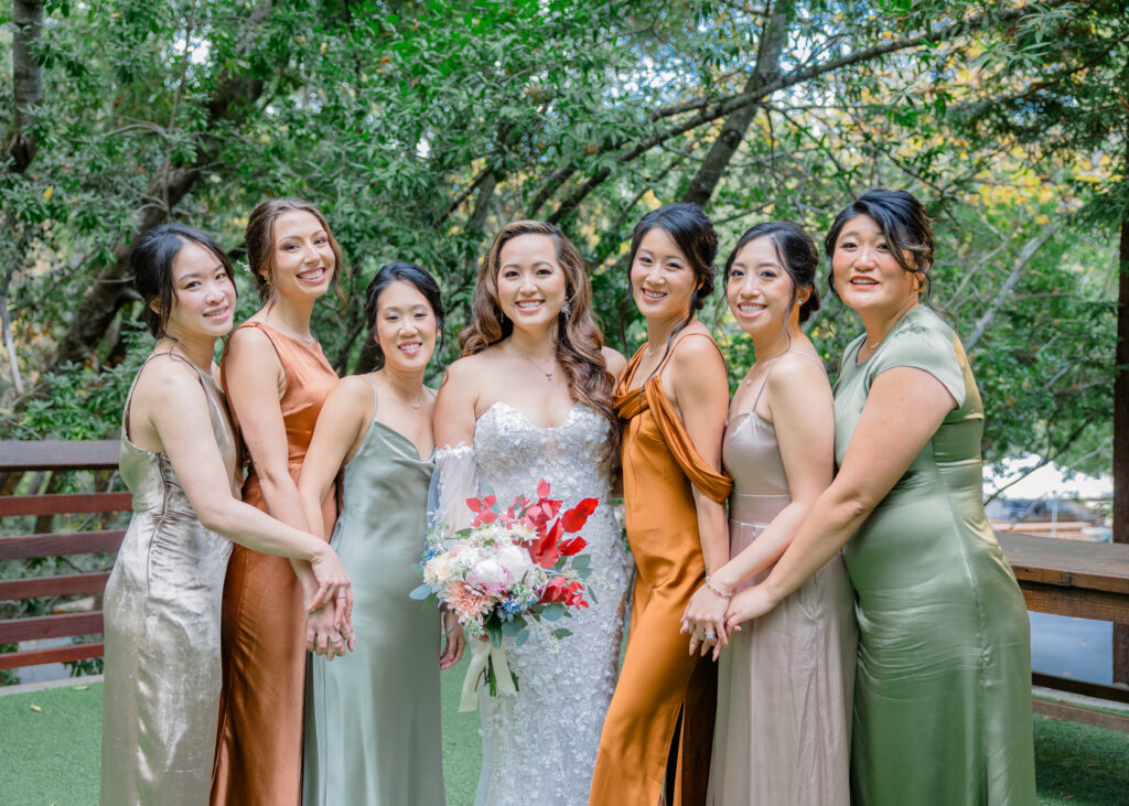 A bridal party showing off flowers